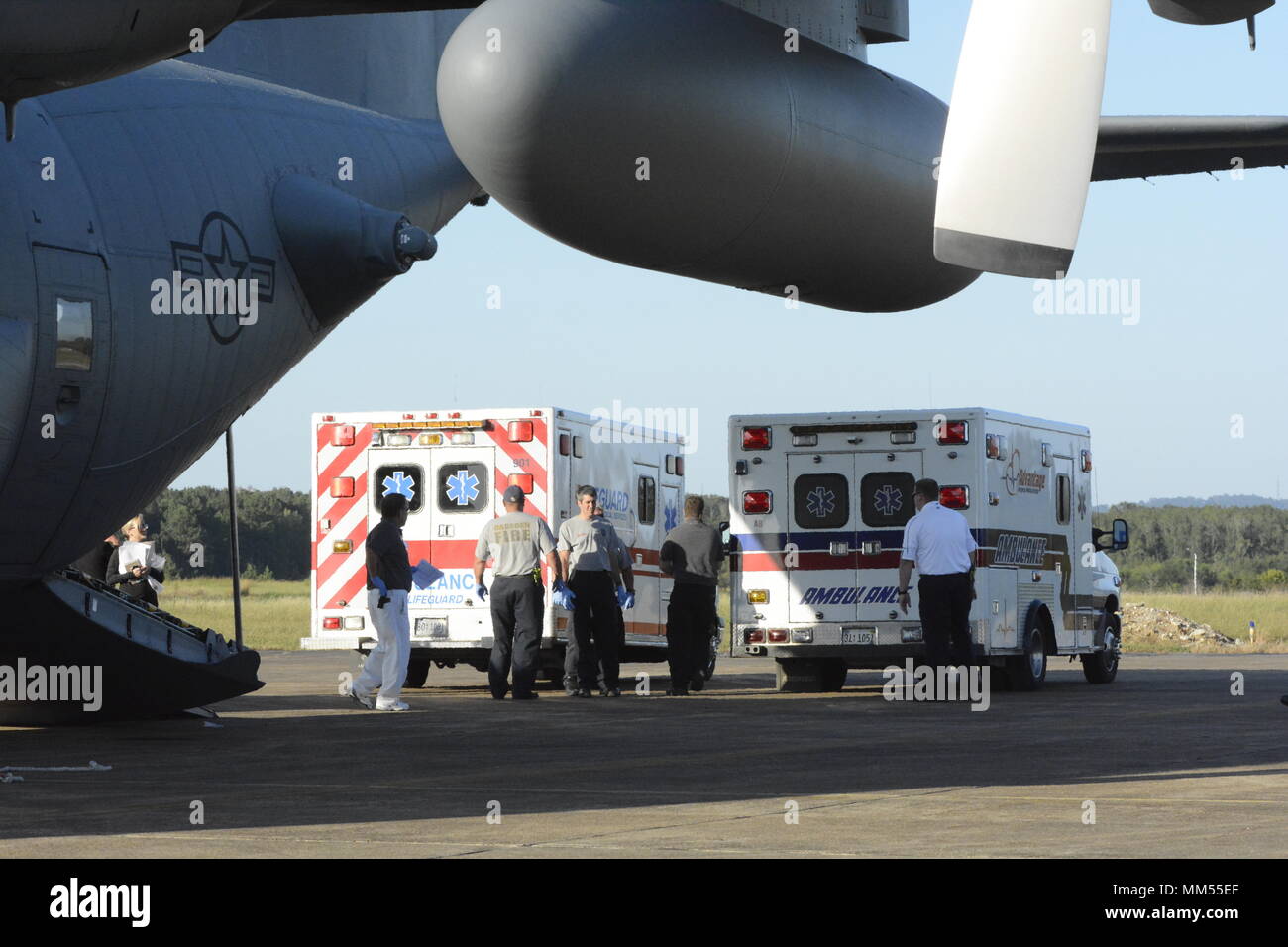 Two ambulances from the Gadsden Alabama Regional Medical Center back up to a North Carolina Air National Guard C-130 Hercules to receive patients evacuated from Key West Florida prior to the arrival of Hurricane Irma, the 156th Aeromedical Evacuation Squadron transported eleven patients into the hands of Gadsden Alabama first responders, while at the Northeast Alabama Regional Airport, Gadsden Alabama, Sept. 6, 2017. Hurricane Irma is a category five storm that is expected to cause catastrophic damage to the regions it makes landfall. The 156th Aeromedical Evacuation Squadron of the North Caro Stock Photo