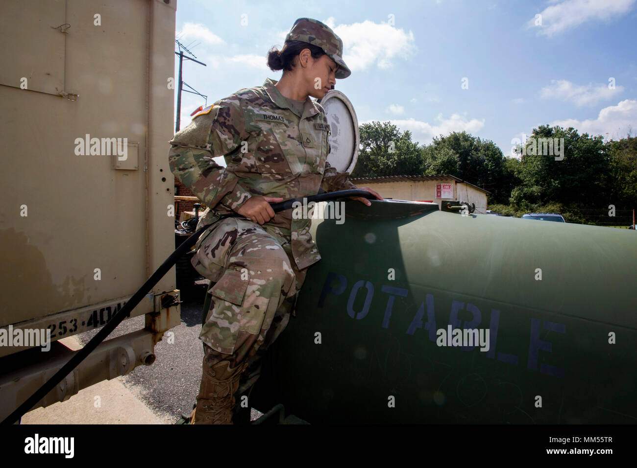 U.S. Army Pfc. Michaela Thomas, 253rd Transportation Company, fills a 400 gallon water trailer as more than 130 New Jersey Army National Guard Soldiers at Cape May Courthouse, N.J., prepare to deploy to support the Florida National Guard in anticipation of Hurricane Irma Sept. 7, 2017. (New Jersey National Guard photo by Mark C. Olsen/Released) Stock Photo