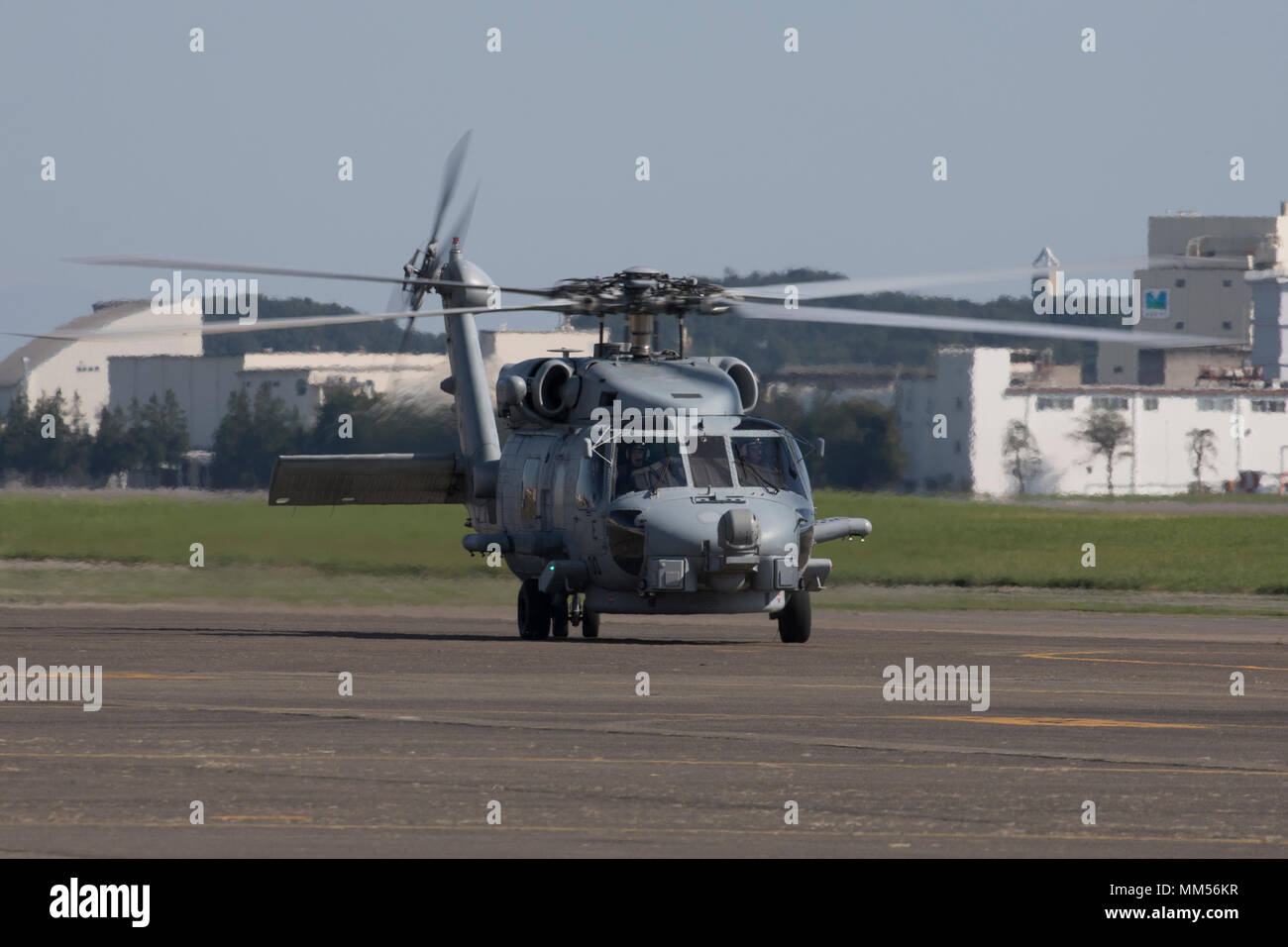 A U.S. Navy MH-60R Seahawk assigned to Helicopter Maritime Strike Squadron (HSM) 51, Naval Air Facility Atsugi, taxis the flight line at Yokota Air Base, Japan, Sept. 3, 2017, during the Tokyo Metropolis Comprehensive Disaster Prevention Drill. U.S. military helicopters from Naval Air Facility Atsugi, Camp Zama, and Yokota participated in the drill, where humanitarian supplies were offloaded from each aircraft at Yokota to simulate the interoperability of U.S. and Tokyo Metropolitan Government in responding to a natural disaster. (U.S. Air Force photo by Yasuo Osakabe) Stock Photo