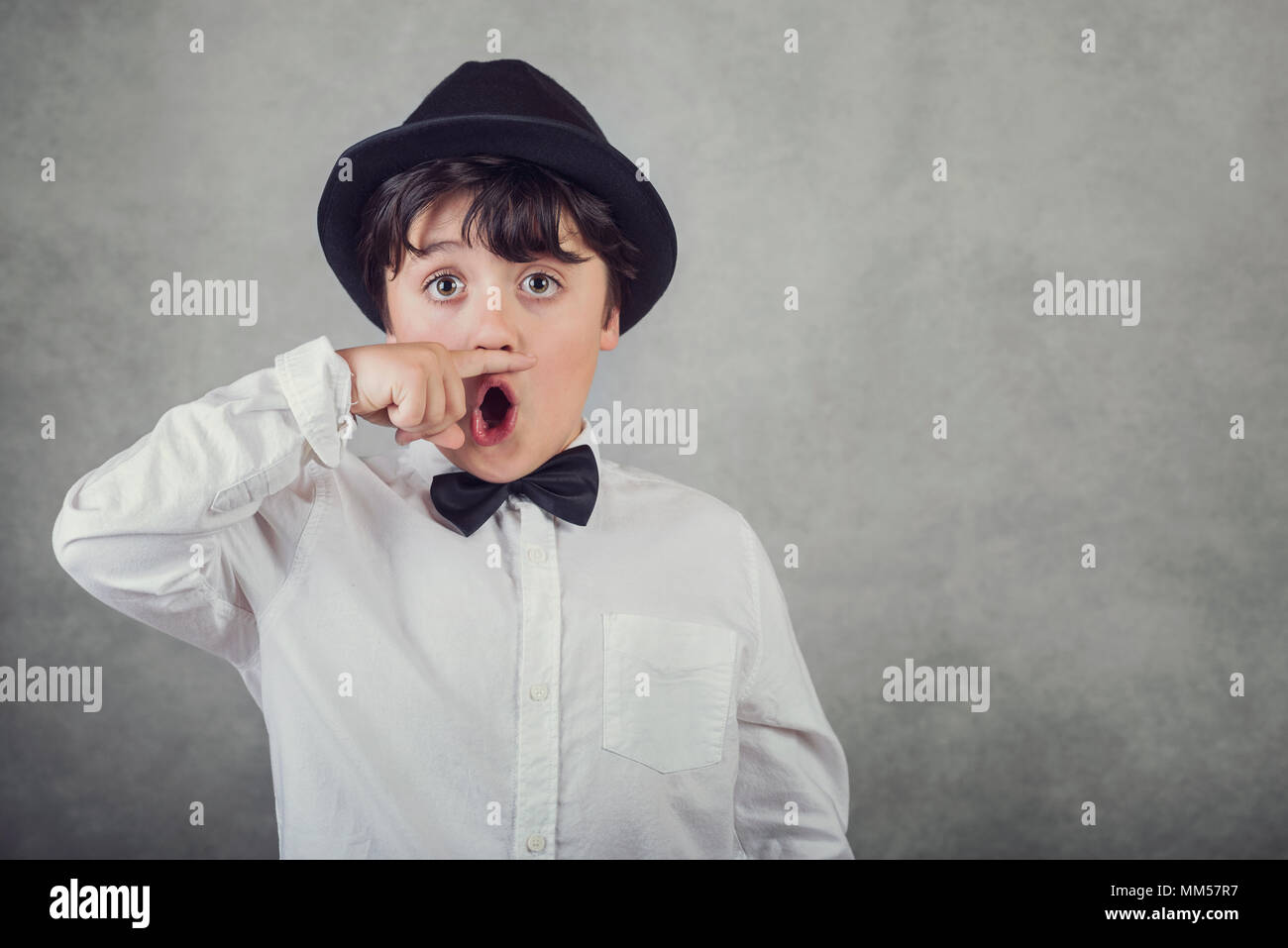 funny boy with hat and bow tie on gray background Stock Photo
