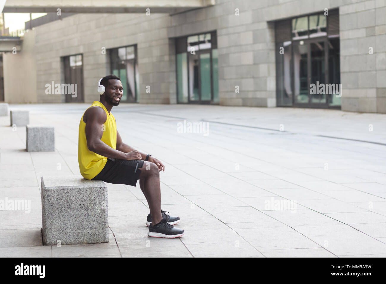 Young afro american man sitting hi-res stock photography and images - Alamy