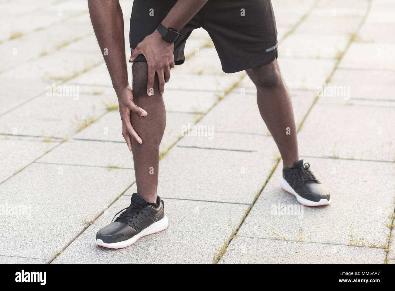 Sports injury concept. Problems with joints in athletes after jogging. Outdoor shot, morning. Spring or summer Stock Photo