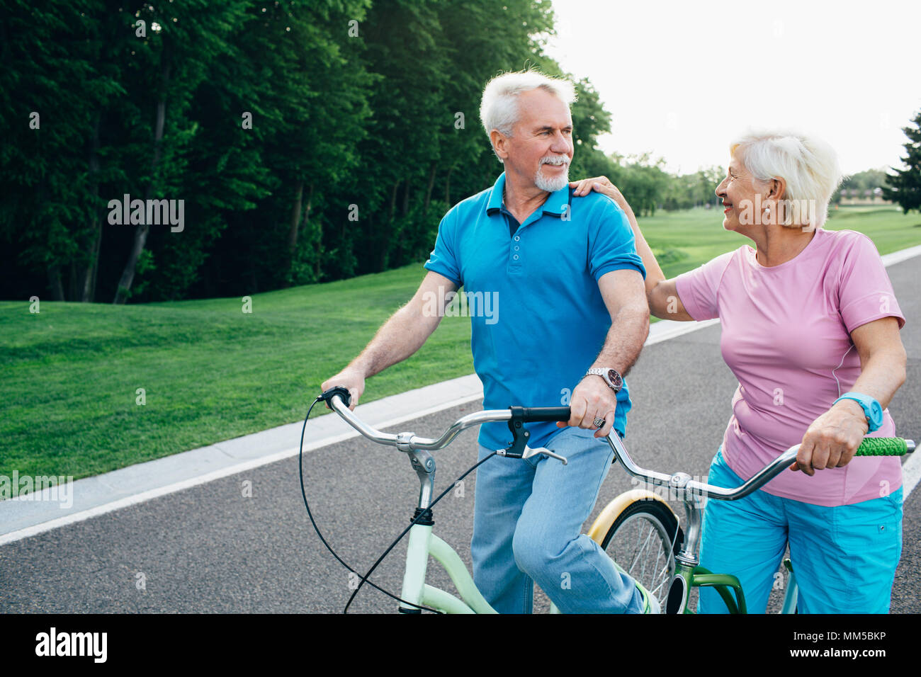 Happy senior couple riding bicycles Stock Photo