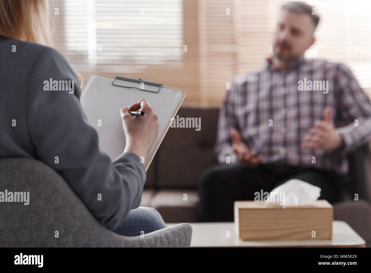 Close-up of psychotherapist analyzing patient's problem in the office Stock Photo