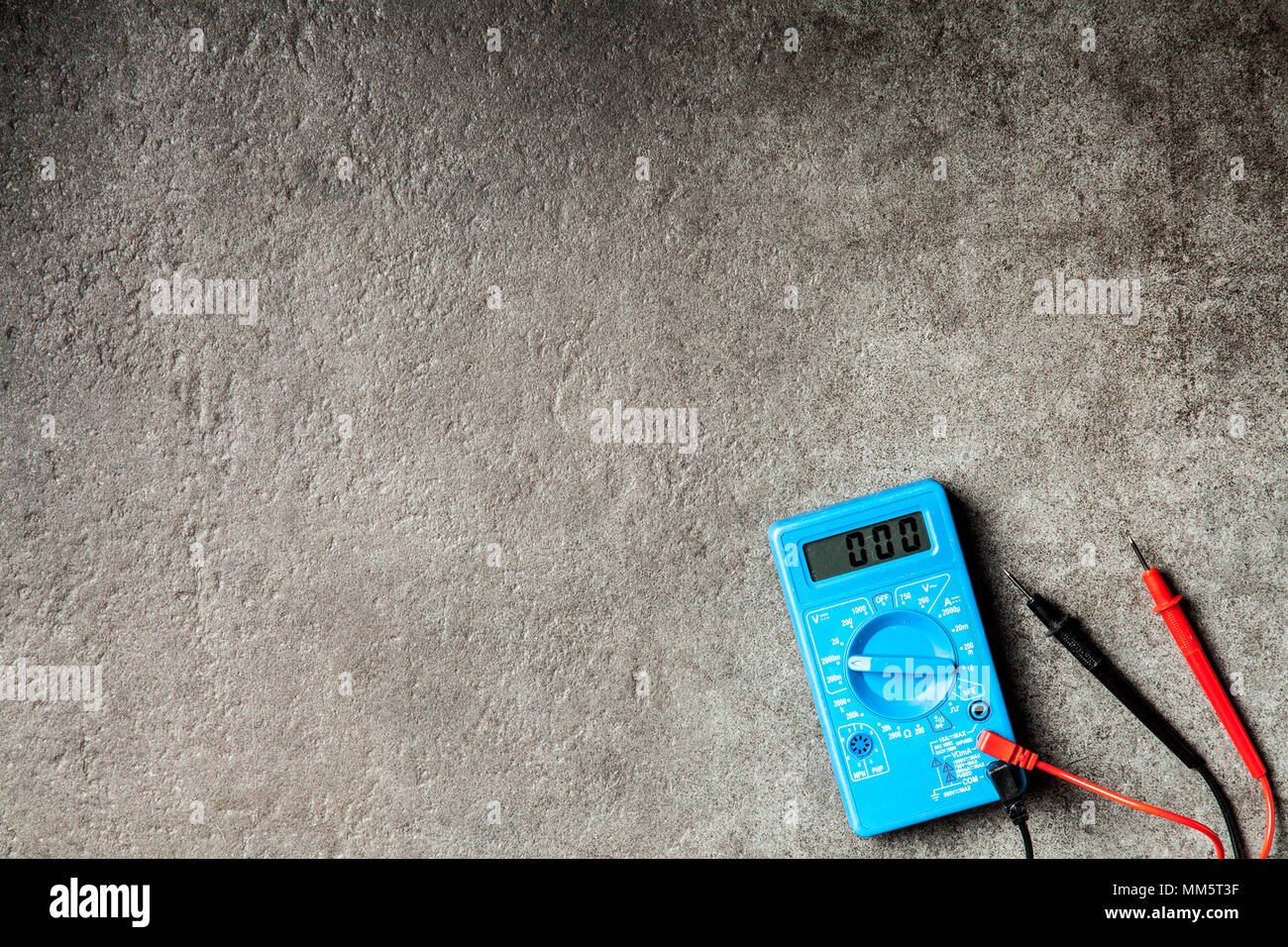 Blue digital multimeter on grey background Stock Photo - Alamy