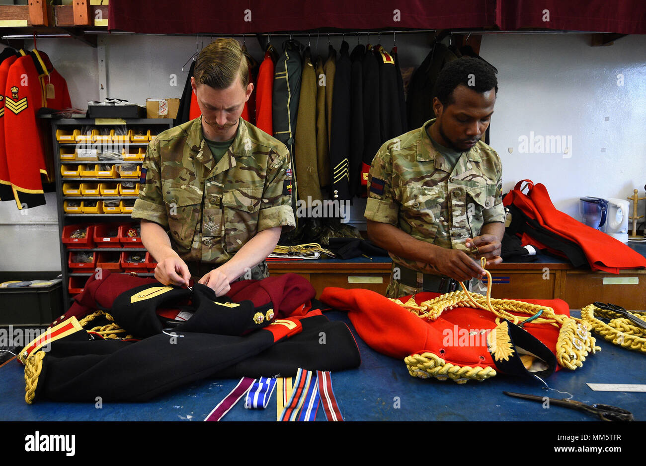 Members of the Household Calvary works in the Tailors Shop during a facility to see The Household Cavalry Mounted Regiment preparations for the forthcoming Royal Wedding at Hyde Park Barracks, central London. Stock Photo