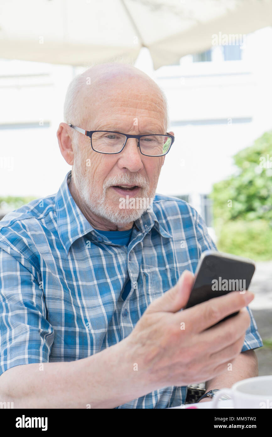 Senior man using smart phone Stock Photo