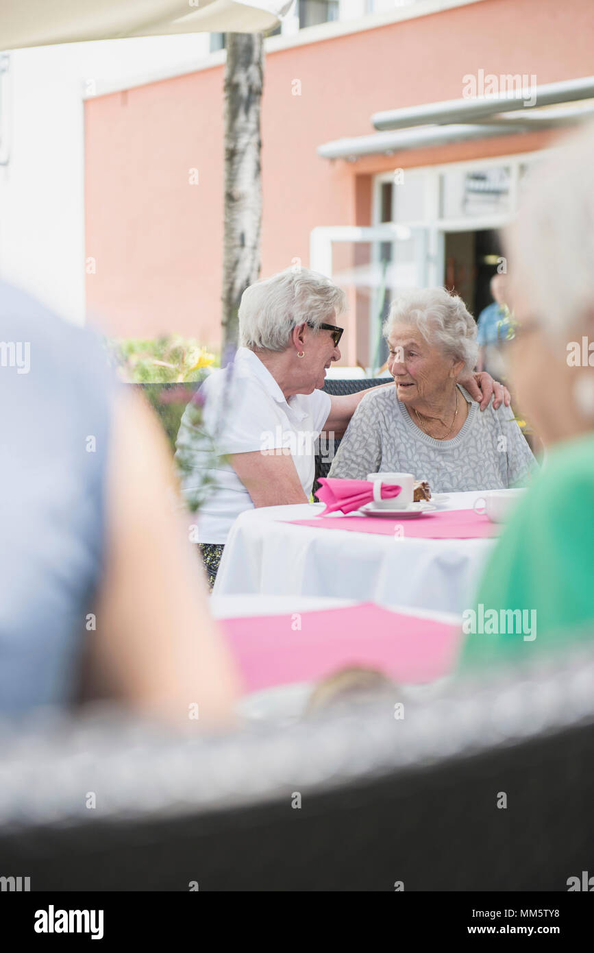 Senior women sitting outdoors Stock Photo