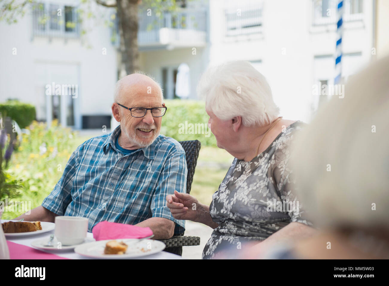Senior people talking on breakfast table Stock Photo