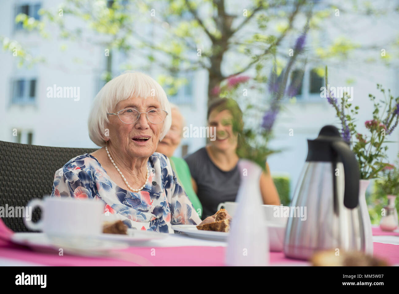 Senior woman at breakfast table Stock Photo