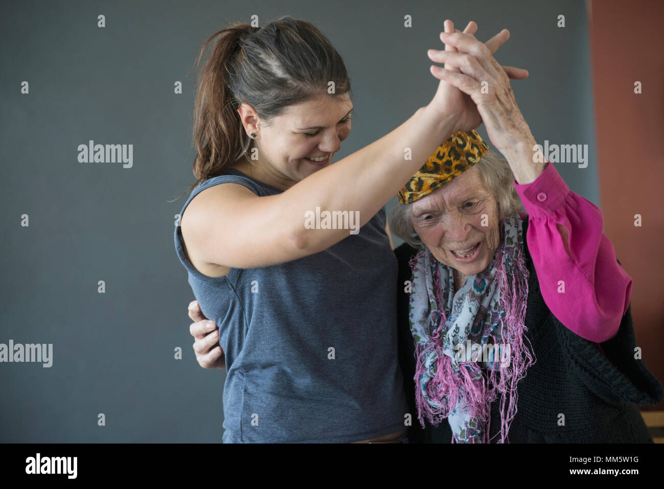 Grandmother and granddaughter dancing together Stock Photo