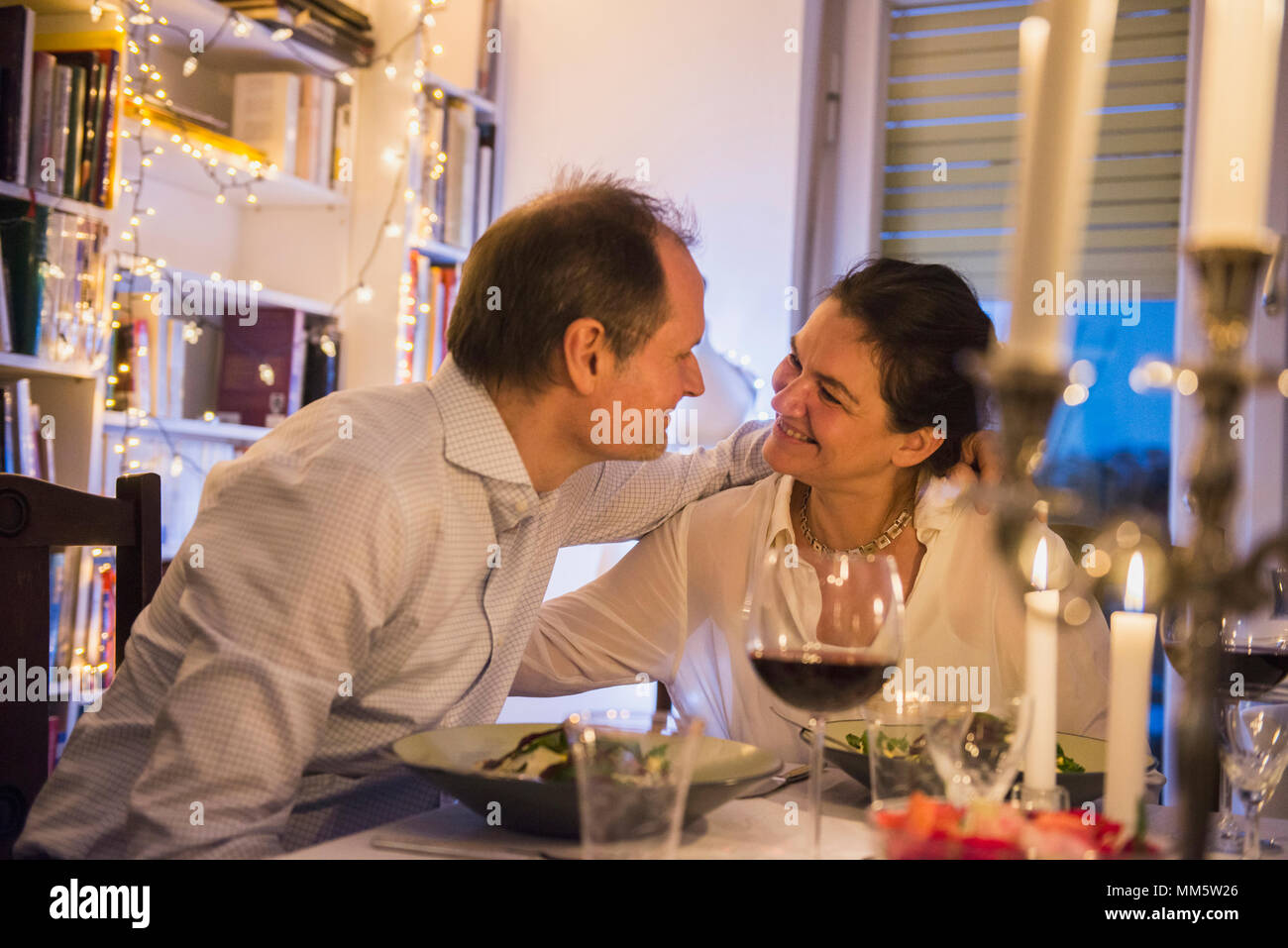 Couple embracing each other at a candlelight dinner Stock Photo