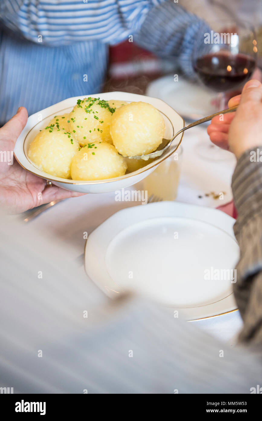 Father and son with potato dish during christmas celebration Stock Photo