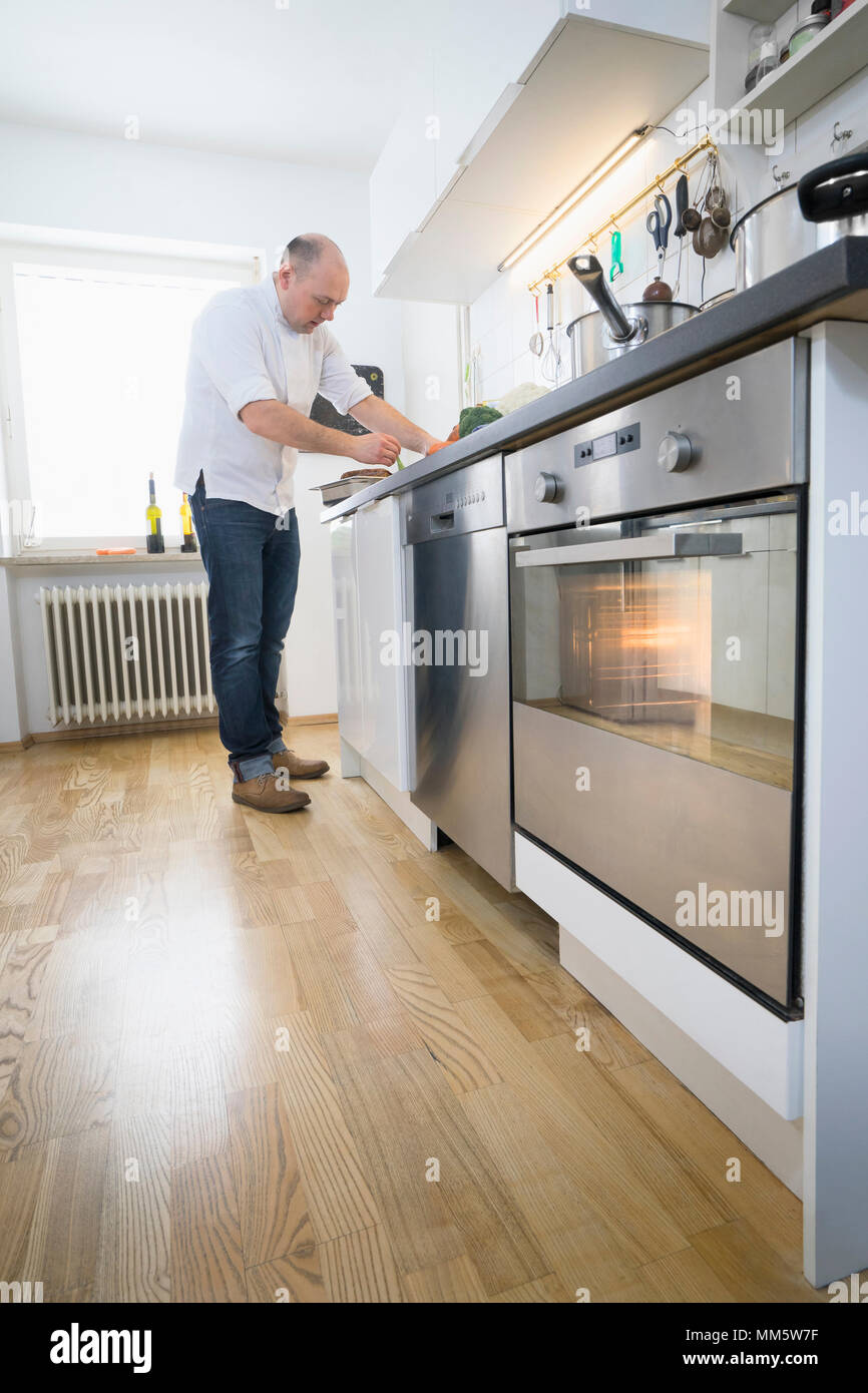 Cook cooking in private kitchen Stock Photo