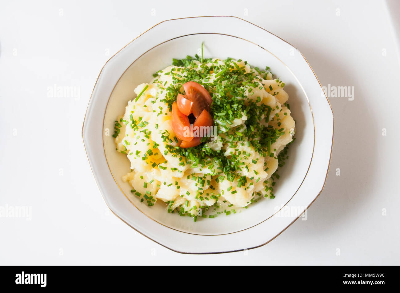 Potato salad with parsley and tomato Stock Photo