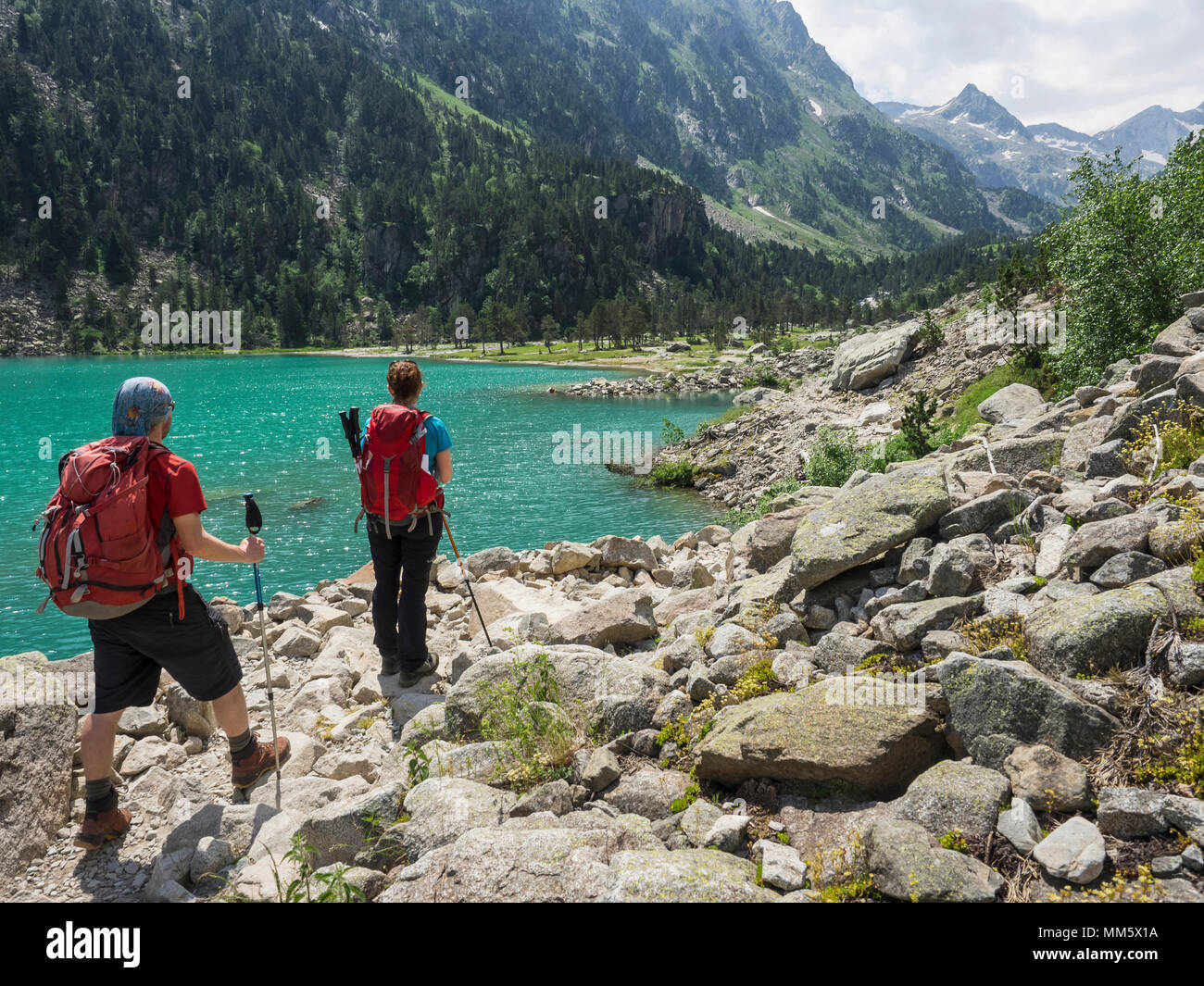 Man and woman hiking in the High Pyrenees near Gaube Lake, Cauterets, France Stock Photo