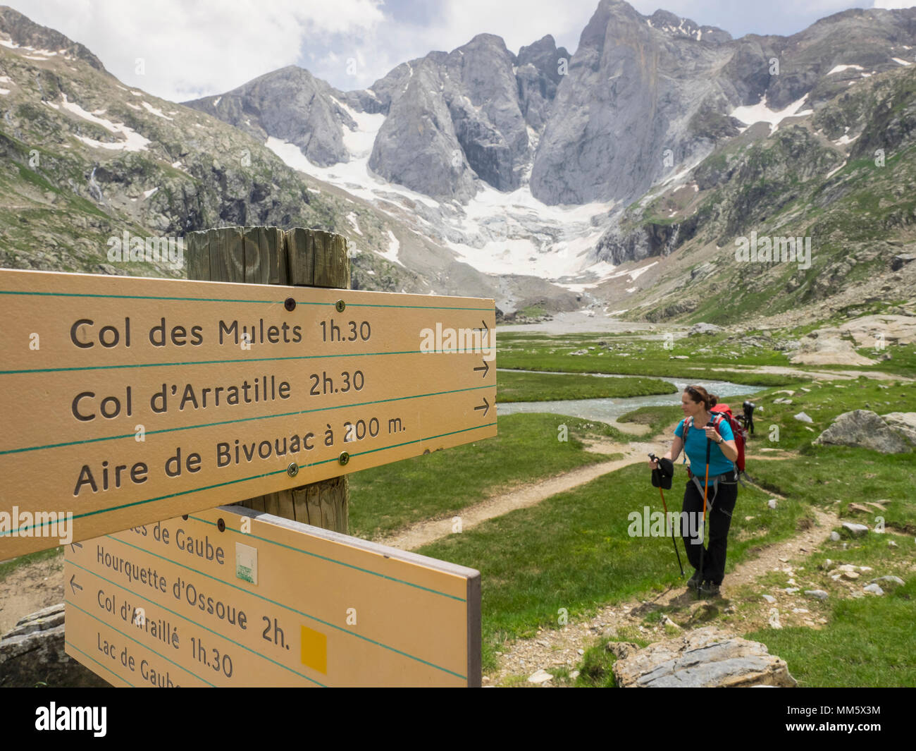 Woman hiking in the High Pyrenees in front of mount Vignemale ...