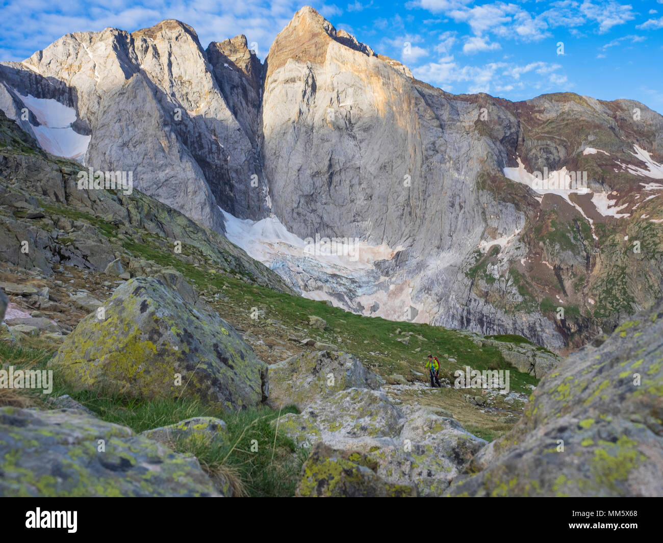 Woman hiking in the High Pyrenees ascending to mount Vignemale ...