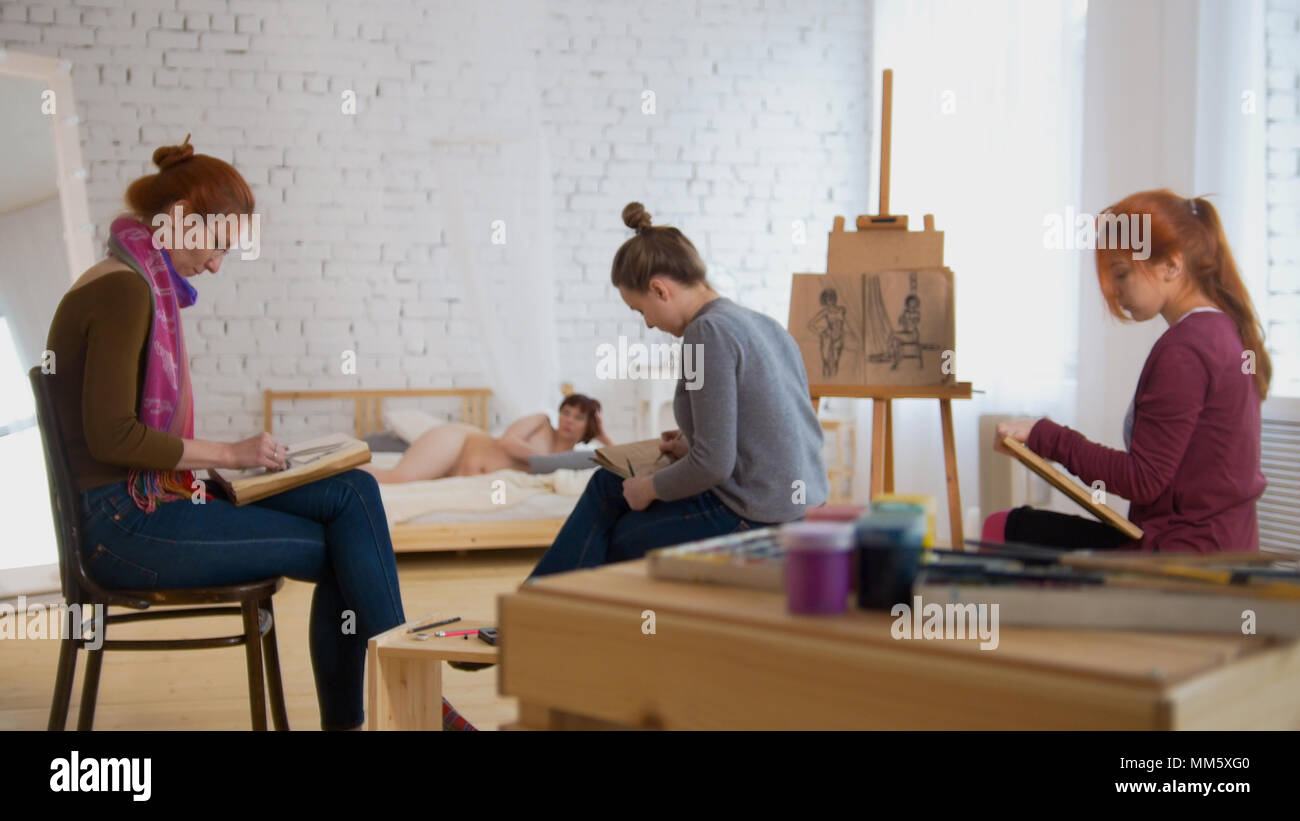 Young women artists painting picture in art studio Stock Photo - Alamy