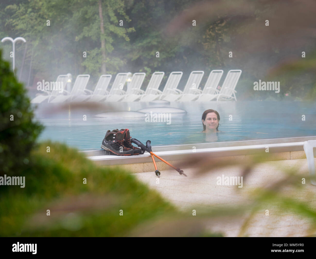 Woman hiker relaxing in swimming pool of ParacelsusTherme, "Bad