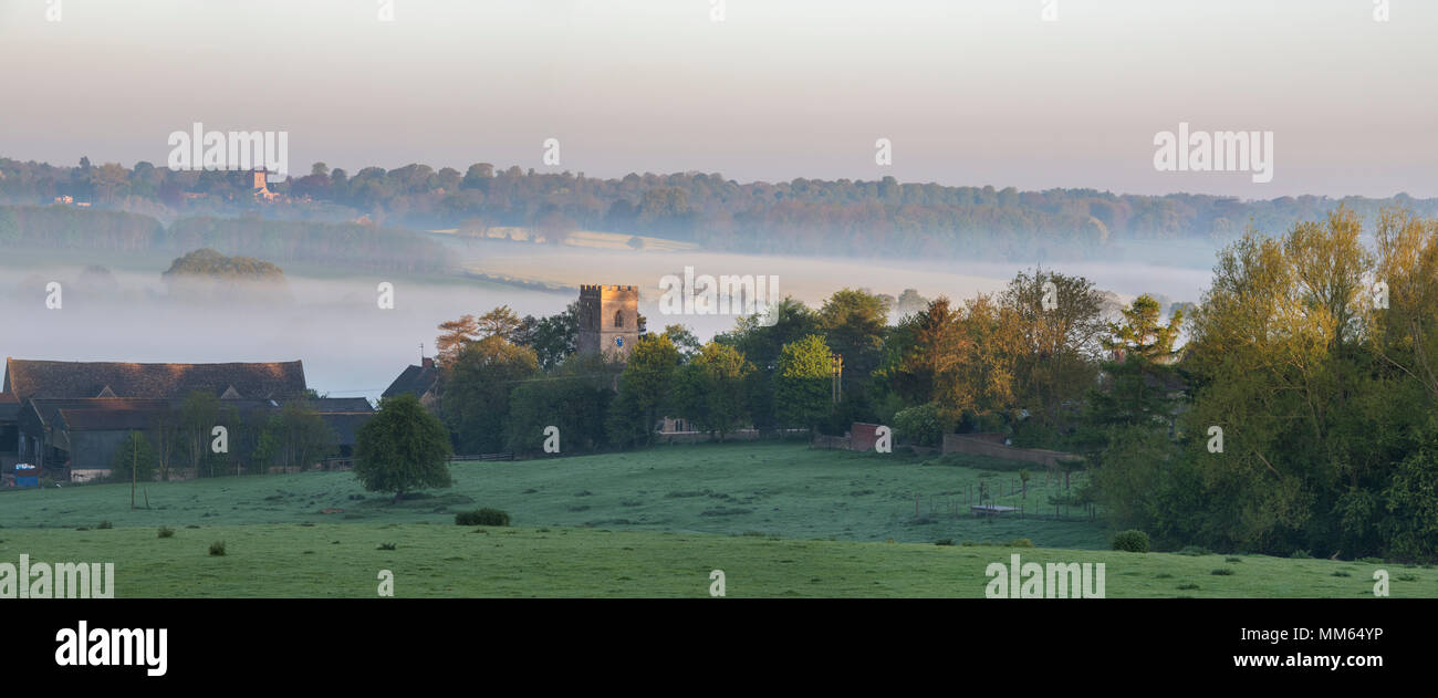 St Marys Church Upper Heyford in spring at sunrise. Upper Heyford, Oxfordshire, England. Panoramic Stock Photo