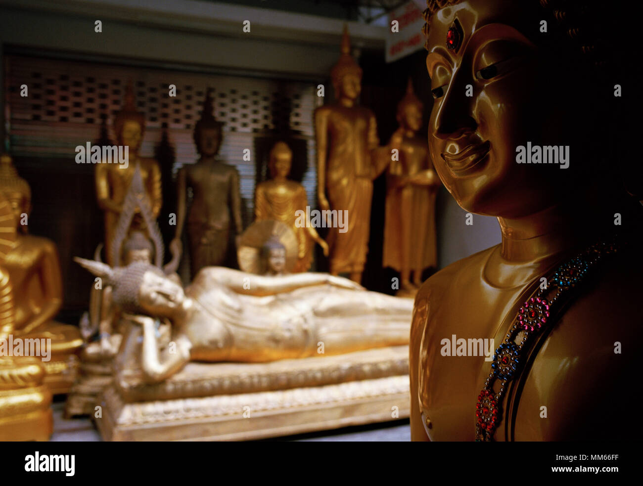 Thai Buddhism - Reclining Buddha statue art for sale in Bamrung Muang Road in Bangkok in Thailand in Southeast Asia Far East. Buddhist Serenity Stock Photo