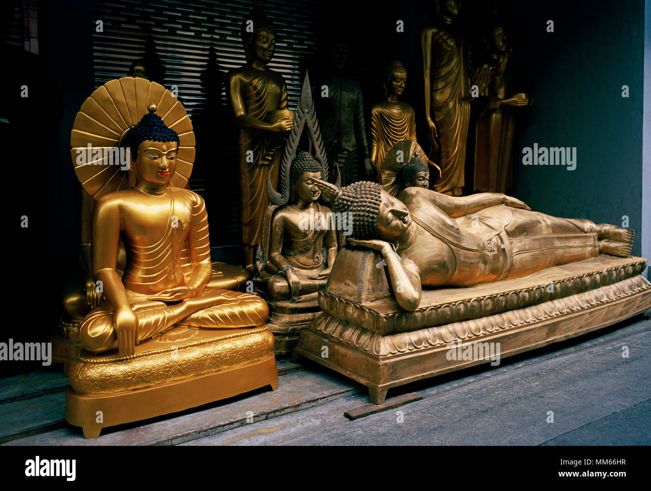 Thai Buddhism - Reclining Buddha statue art for sale in Bamrung Muang Road in Bangkok in Thailand in Southeast Asia Far East. Buddhist Serenity Stock Photo