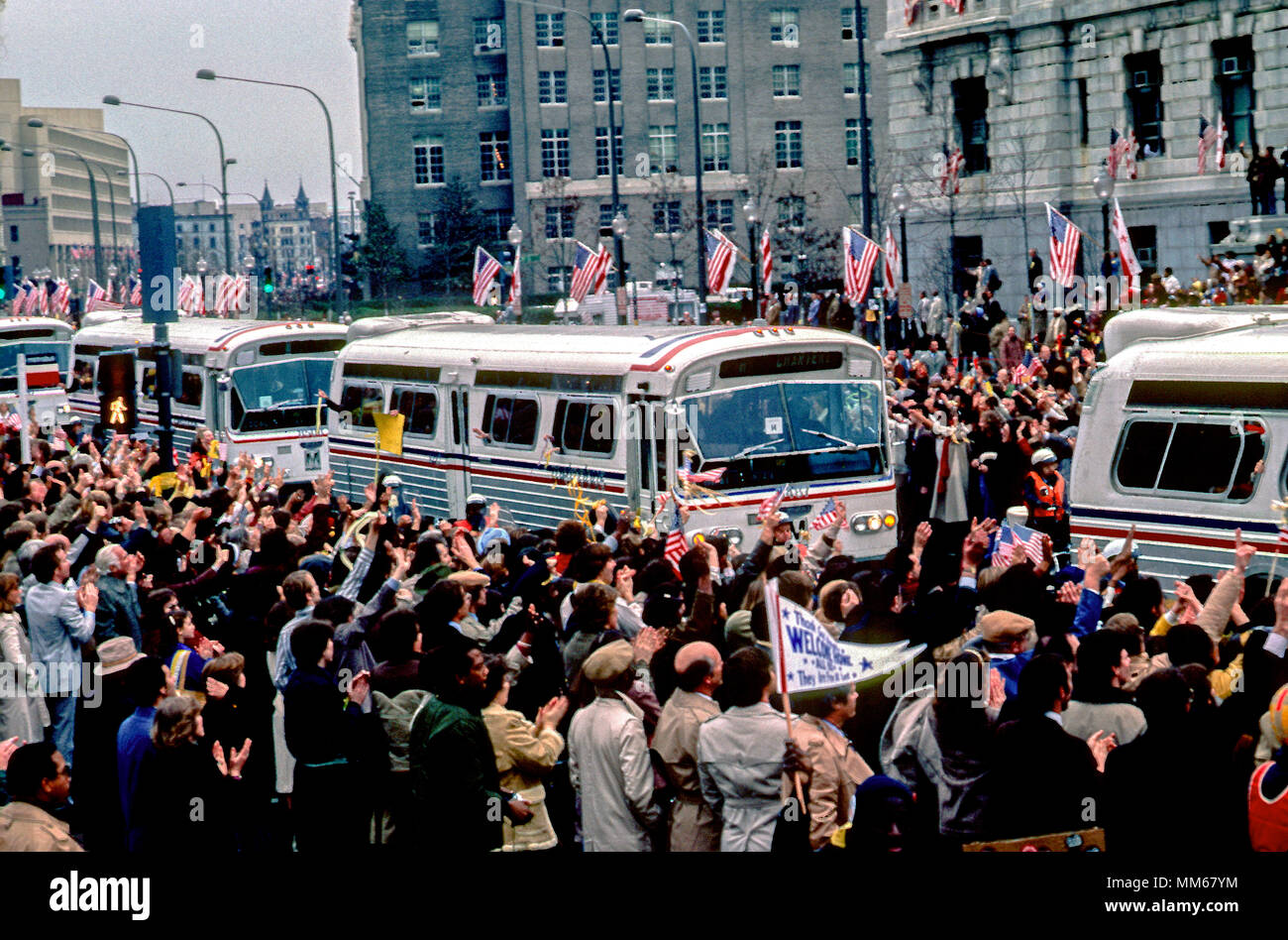 washington-dc-usa-january-27-1981-the-buses-carrying-the-52-americans-who-were-held-hostage-by-the-iranians-for-444-days-are-welcomed-home-by-a-massive-crowd-waving-symbolic-yellow-ribbons-along-pennsylvania-avenue-at-freedom-plaza-MM67YM.jpg