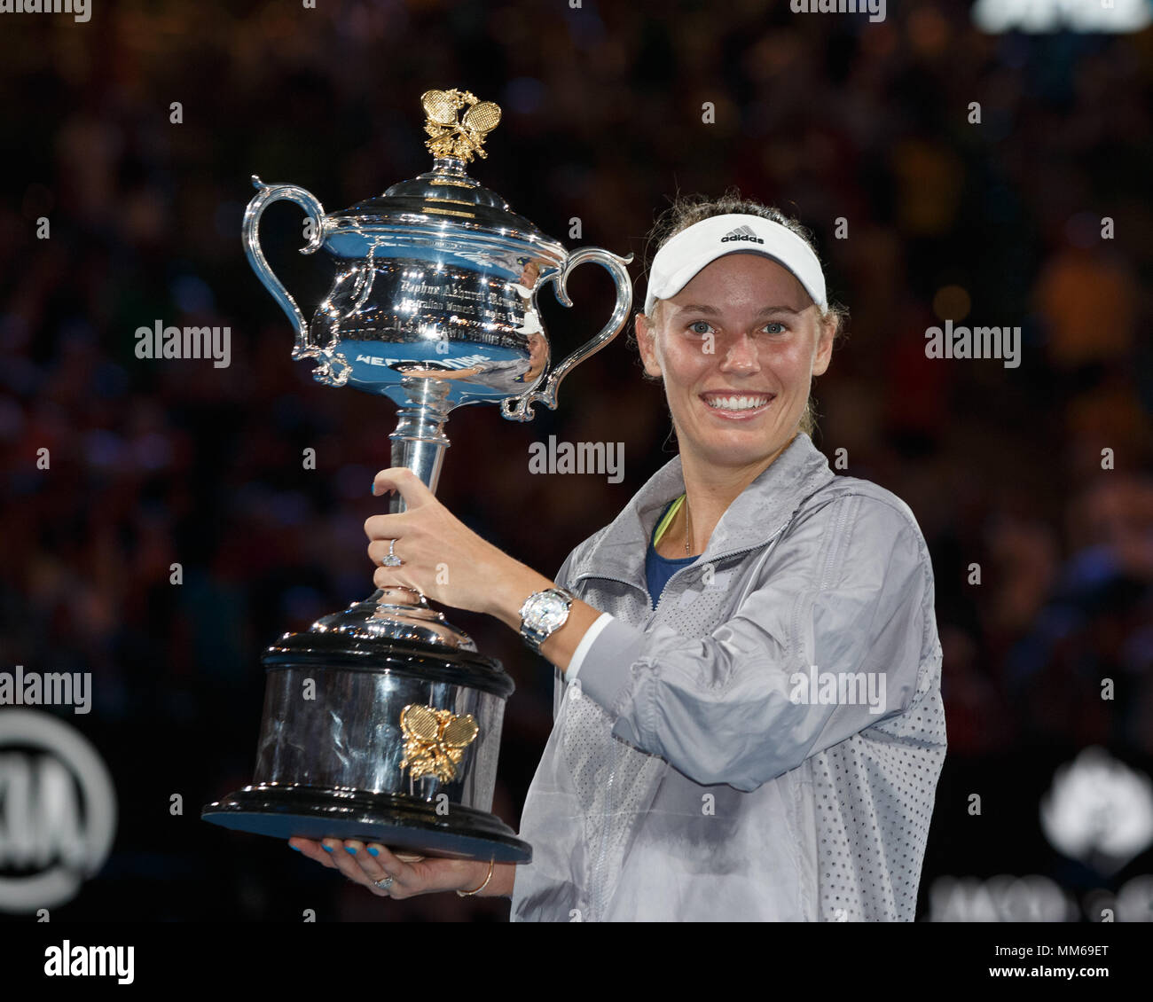 Professional sportsperson sportswear looking at camera standing holding
