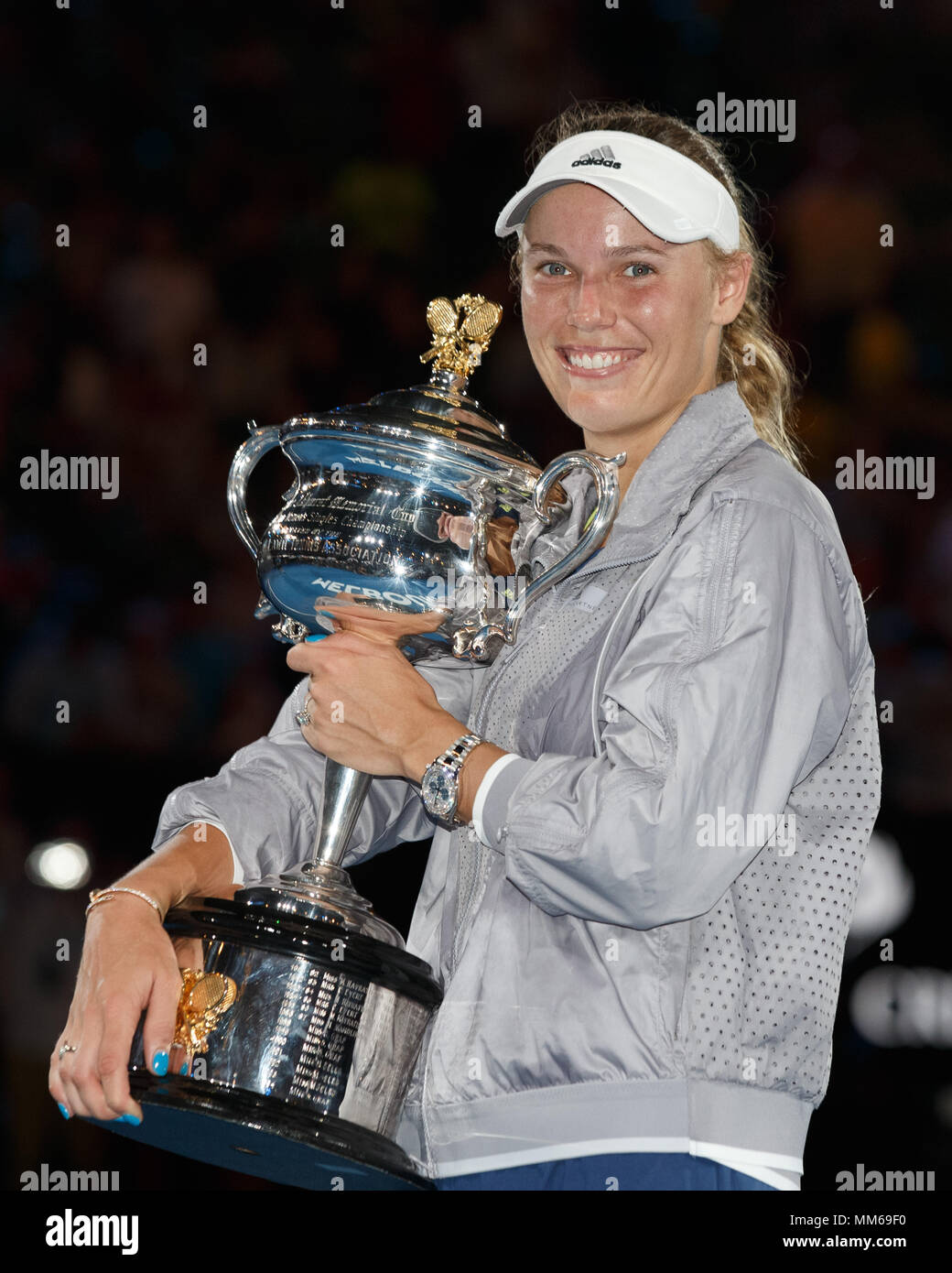 Professional sportsperson sportswear looking at camera standing holding