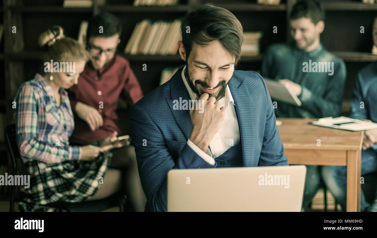 sales Manager with laptop on the background of business team in Stock Photo