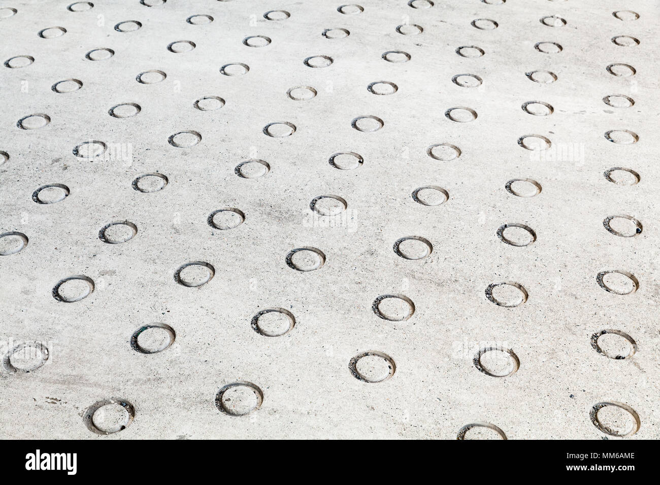 Concrete flooring with round relief pattern, background photo texture Stock Photo