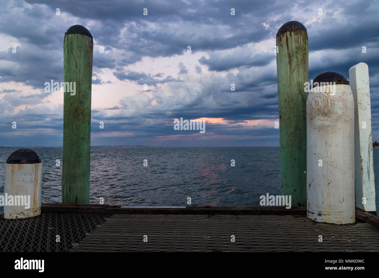 White and green pillars during sunset at the jetty of Cowes, Phillip Island, Australia Stock Photo