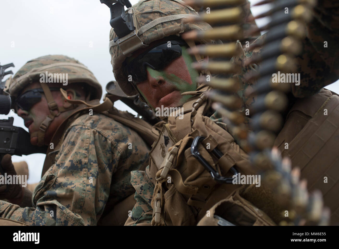 POHAKULOA TRAINING AREA, HAWAII -- Cpl. Tyler Stallings, a machine gunner with India Company, 3rd Battalion, 3rd Marine Regiment, prepares an ammunition belt during an air assault training event at Pohakuloa Training Area, Sept. 3, 2017. Marine Heavy Helicopter Squadron 463 carried Marines with India Co. from Landing Zone Dove to Range 17, where they carried out platoon attacks with support from 60mm mortars and multiple machine gun emplacements. Exercise Bougainville II prepares 3/3 for service as a forward deployed force in the Pacific by training them to fight as a ground combat element in  Stock Photo