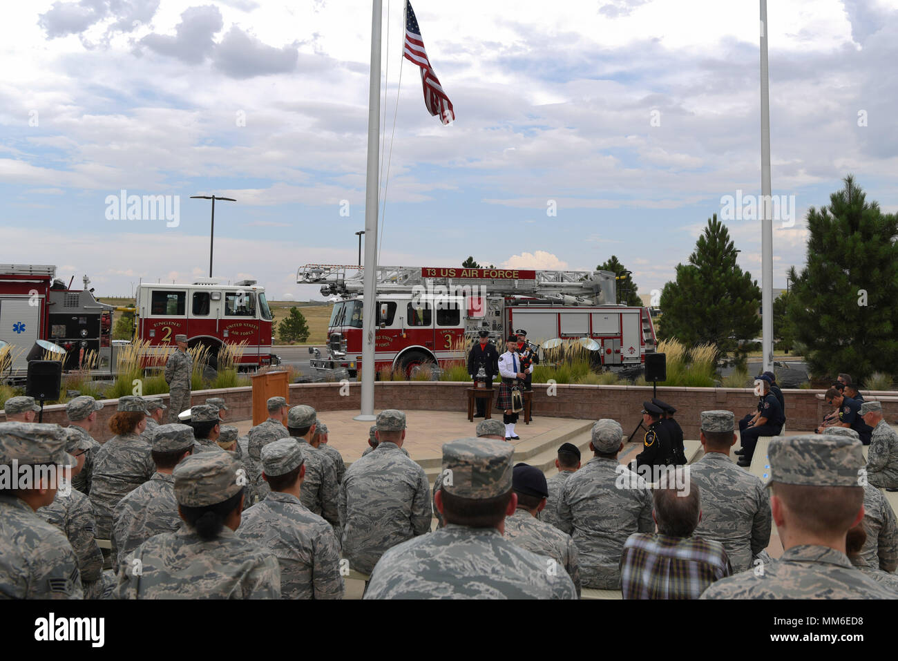 An Aurora Police officer plays Amazing Grace on his bagpipe for Team