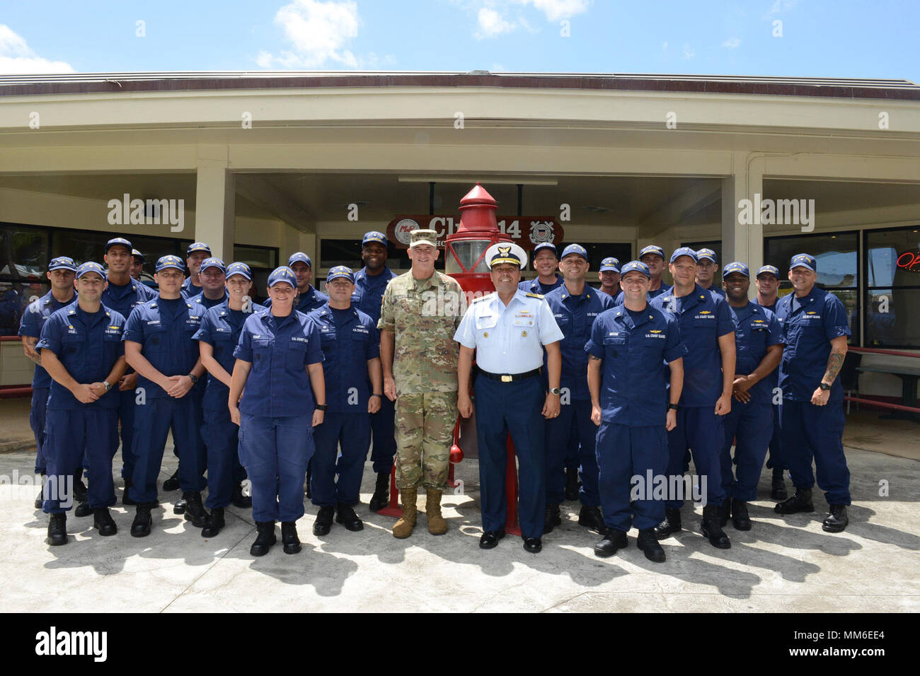 General Robert Brown, commander, U.S. Army Pacific, stands with Rear Adm. Vincent Atkins, commander, Coast Guard 14th District, and crewmembers from throughout the Coast Guard’s 14th District, Sept. 11, 2017. General Brown came to Coast Guard Base Honolulu to personally thank representatives from each unit whom assisted in search efforts for the helicopter crew missing off of Oahu in August. (U.S. Coast Guard photo by Petty Officer 3rd Class Amanda Levasseur/Released) Stock Photo