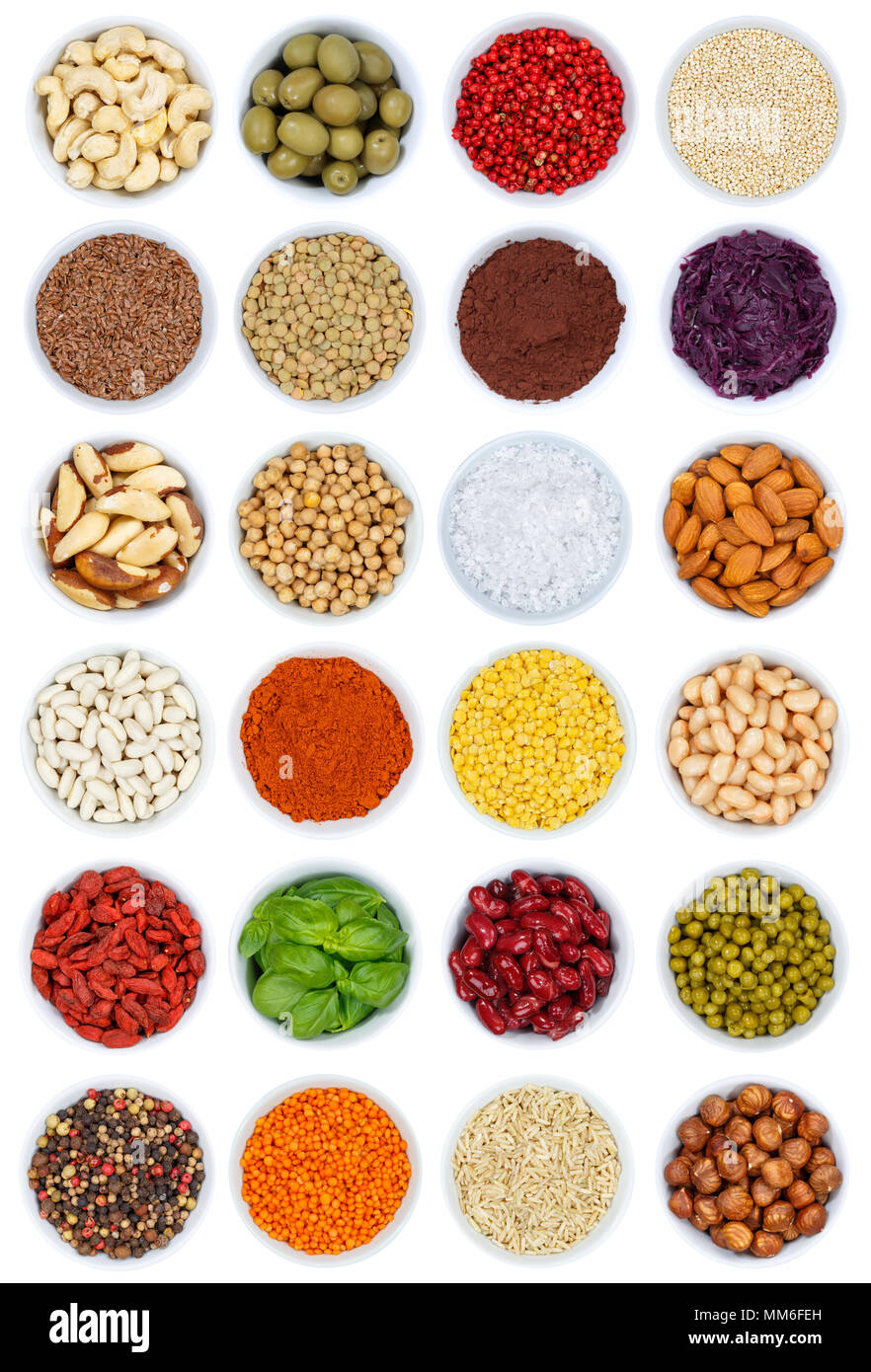 Collection of spices and herbs vegetables nuts portrait format from above bowl isolated on a white background Stock Photo