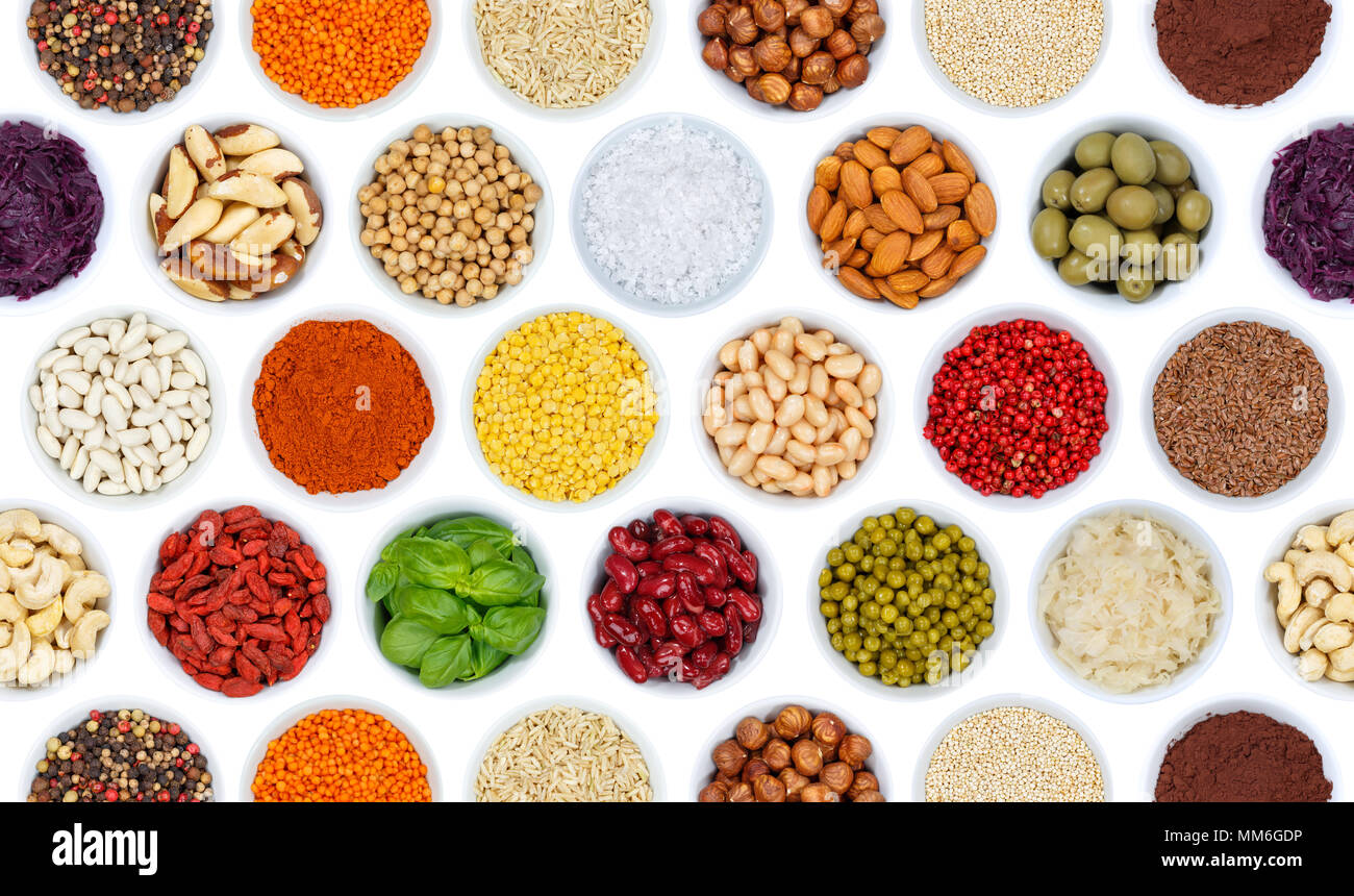Collection of spices and herbs vegetables nuts background from above bowl isolated on a white background Stock Photo