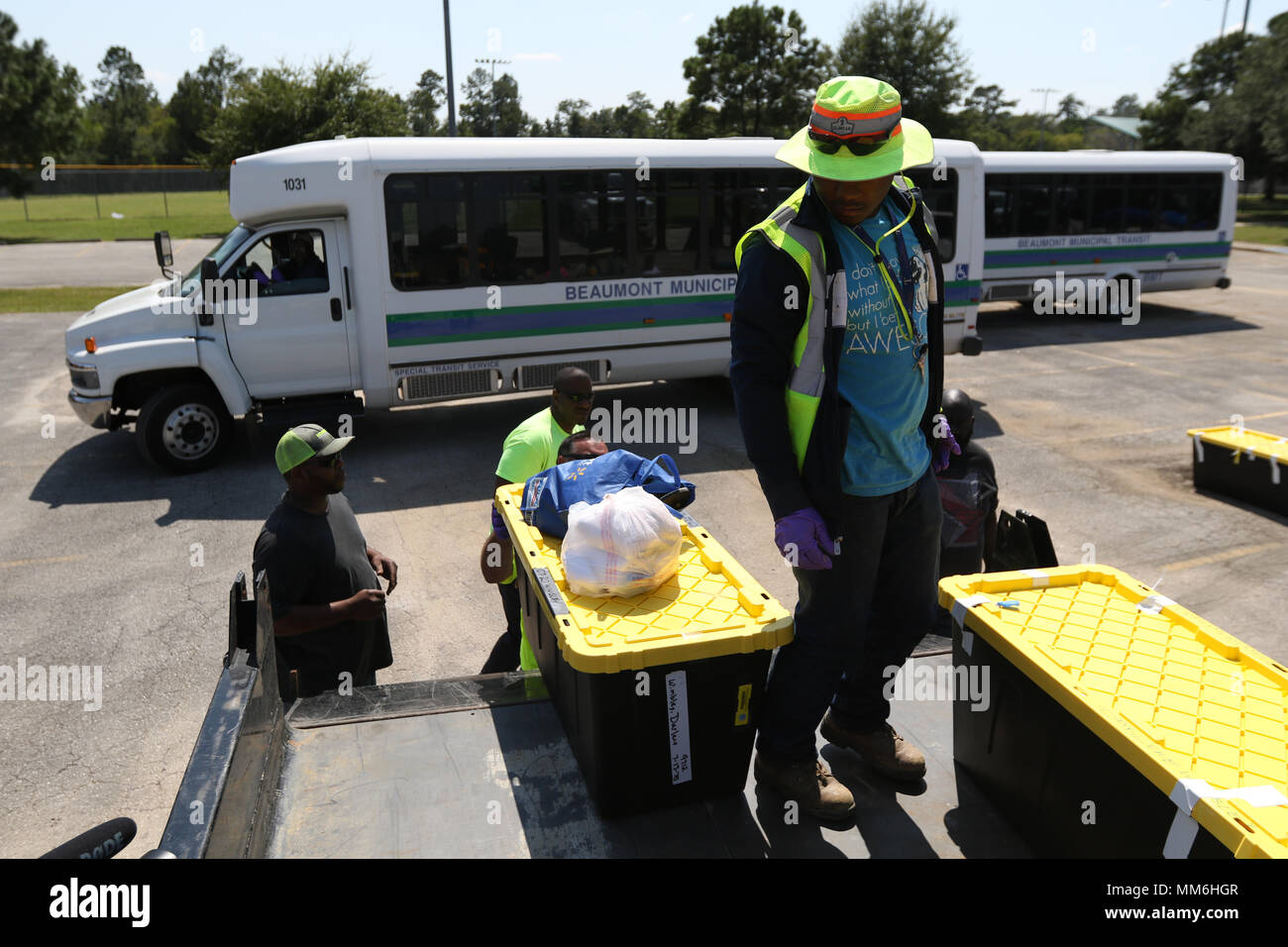 BEAUMONT— Beaumont City workers help load the belongings of local evacuees of Hurricane Harvey at the Municipal Athletic Complex in Beaumont, Sept. 10 2017. The Texas State Guard, Arkansas Army National Guard and the Beaumont Fire Rescue Team also assisted to escort 356 evacuees who had been shuttled from a shelter in Dallas Texas, to either what was left of their homes or to another shelter closer to home in Beaumont. Stock Photo