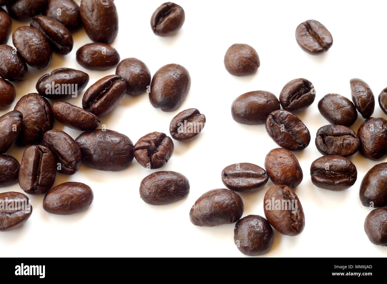 Brown coffee beans isolated on white background Stock Photo - Alamy