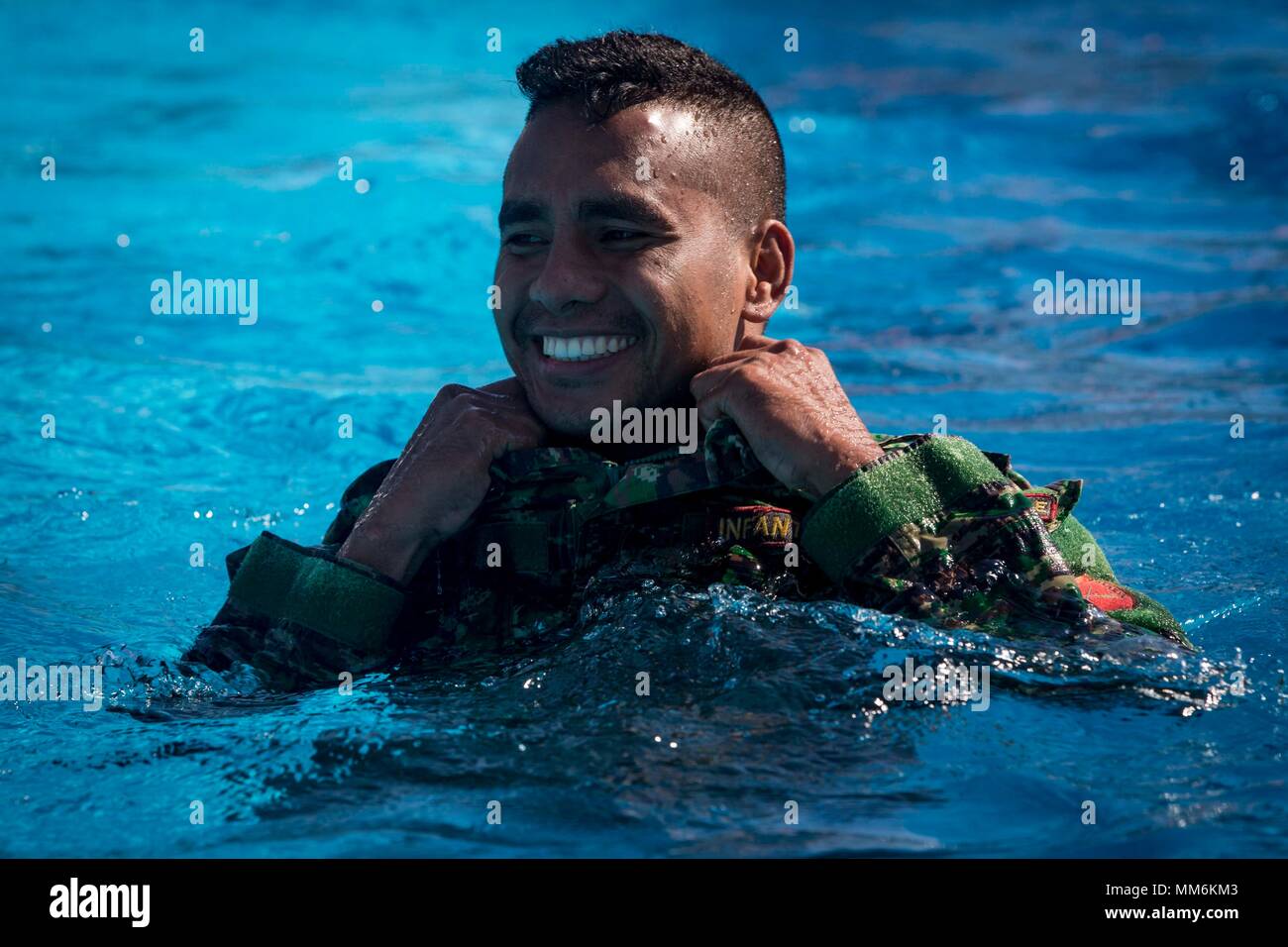 A member of the Falantil Forca de Defensa Timor Leste smiles during Water Survival Training during Exercise Crocodilo as a part of Exercise Koa Moana 17 in Metinaro, Timor Leste, Sept. 9, 2017. Koa Moana 17 is designed to improve interoperability with our partners, enhance military-to-military relations, and expose the Marine Corps forces to different types of terrain for familiarity in the event of a natural disaster in the region.   (U.S. Marine Corps photo by MCIPAC Combat Camera Lance Cpl. Juan C. Bustos) Stock Photo