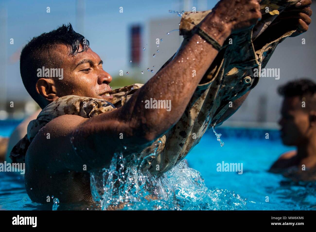 A member of the Falantil Forca de Defensa Timor Leste inflates a pair of trousers during Water Survival Training during Exercise Crocodilo as a part of Exercise Koa Moana 17 in Metinaro, Timor Leste, Sept. 9, 2017. Koa Moana 17 is designed to improve interoperability with our partners, enhance military-to-military relations, and expose the Marine Corps forces to different types of terrain for familiarity in the event of a natural disaster in the region.   (U.S. Marine Corps photo by MCIPAC Combat Camera Lance Cpl. Juan C. Bustos) Stock Photo