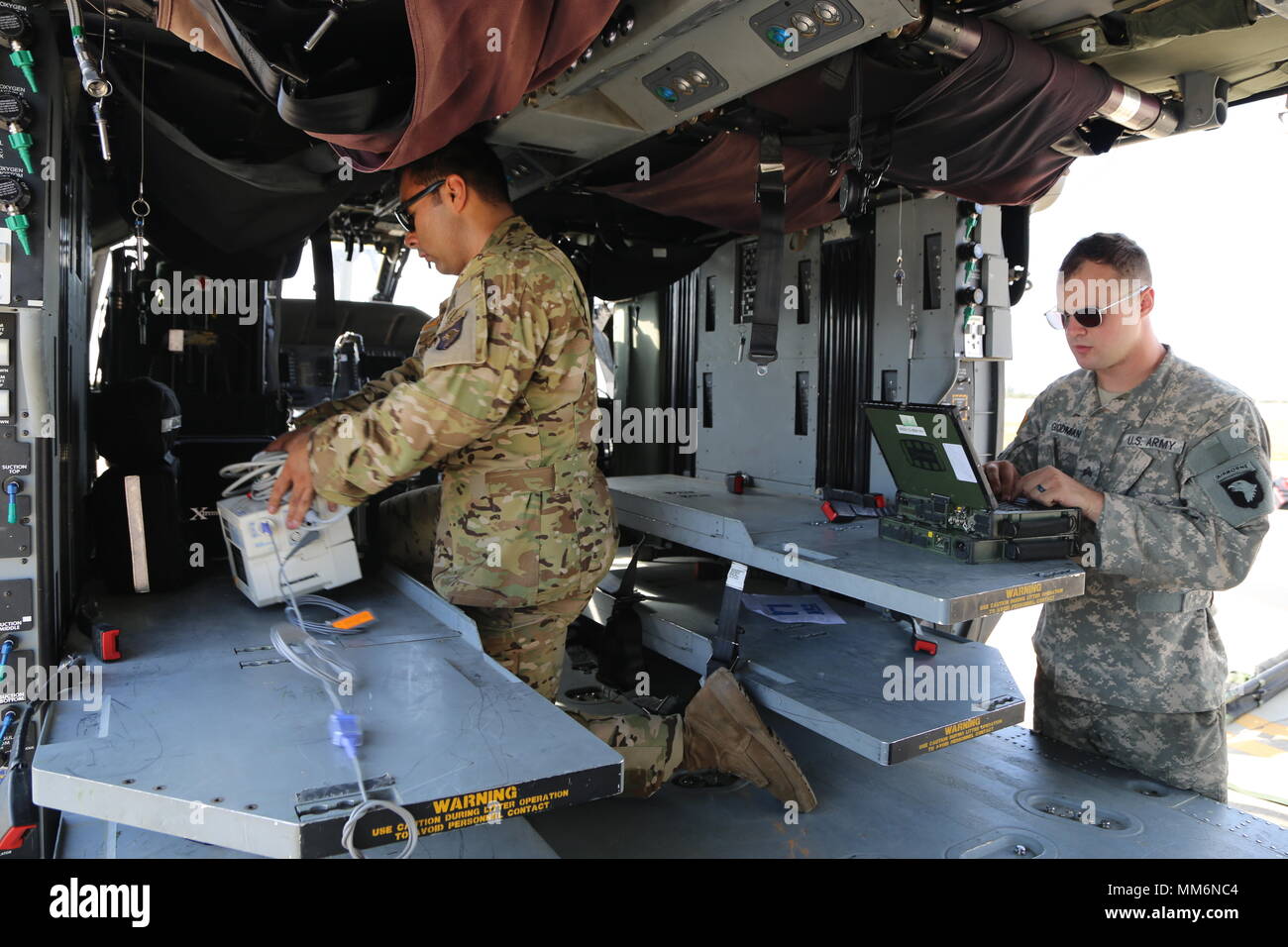 U.S. Army Sgt. Armando Yanez (left) and Sgt. Ryan Goodman, Charlie Company, 6th Battalion, 101st Aviation Regiment, begin preperation of a HH-60M for staging, Patrick Airforce Base, Fl., Sept. 12, 2017. Soldiers stage helicopters in preparation for medical operations in the Hurricane Irma relief process.  (U.S. Army photo by Pfc. Joseph Cannon) Stock Photo