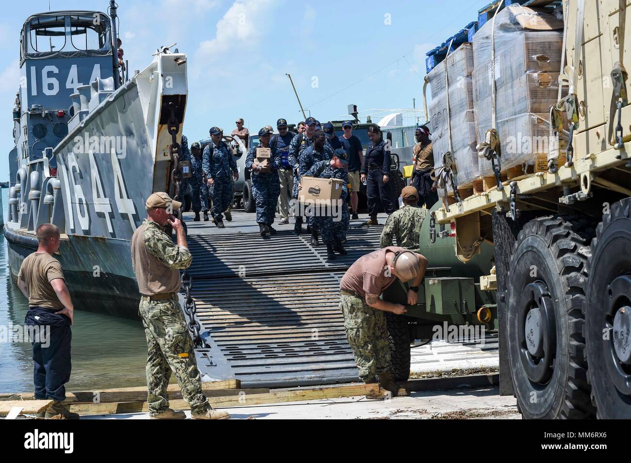 KEY WEST, Fla. (Sept. 13, 2017) Volunteer Sailors from the amphibious assault ship USS Iwo Jima (LHD 7) disembark Landing Craft Unit 1644, attached to Assault Craft Unit (ACU) 2, which is loaded with during humanitarian assistance efforts following Hurricane Irma’s landfall in Key West, Florida. The Department of Defense is supporting Federal Emergency Management Agency, the lead agency, in helping those affixed by Hurricane Irma to minimize suffering and as one component of the overall whole-of-government response efforts.  (U.S. Navy photo by Mass Communication Specialist Seaman Michael Lehm Stock Photo