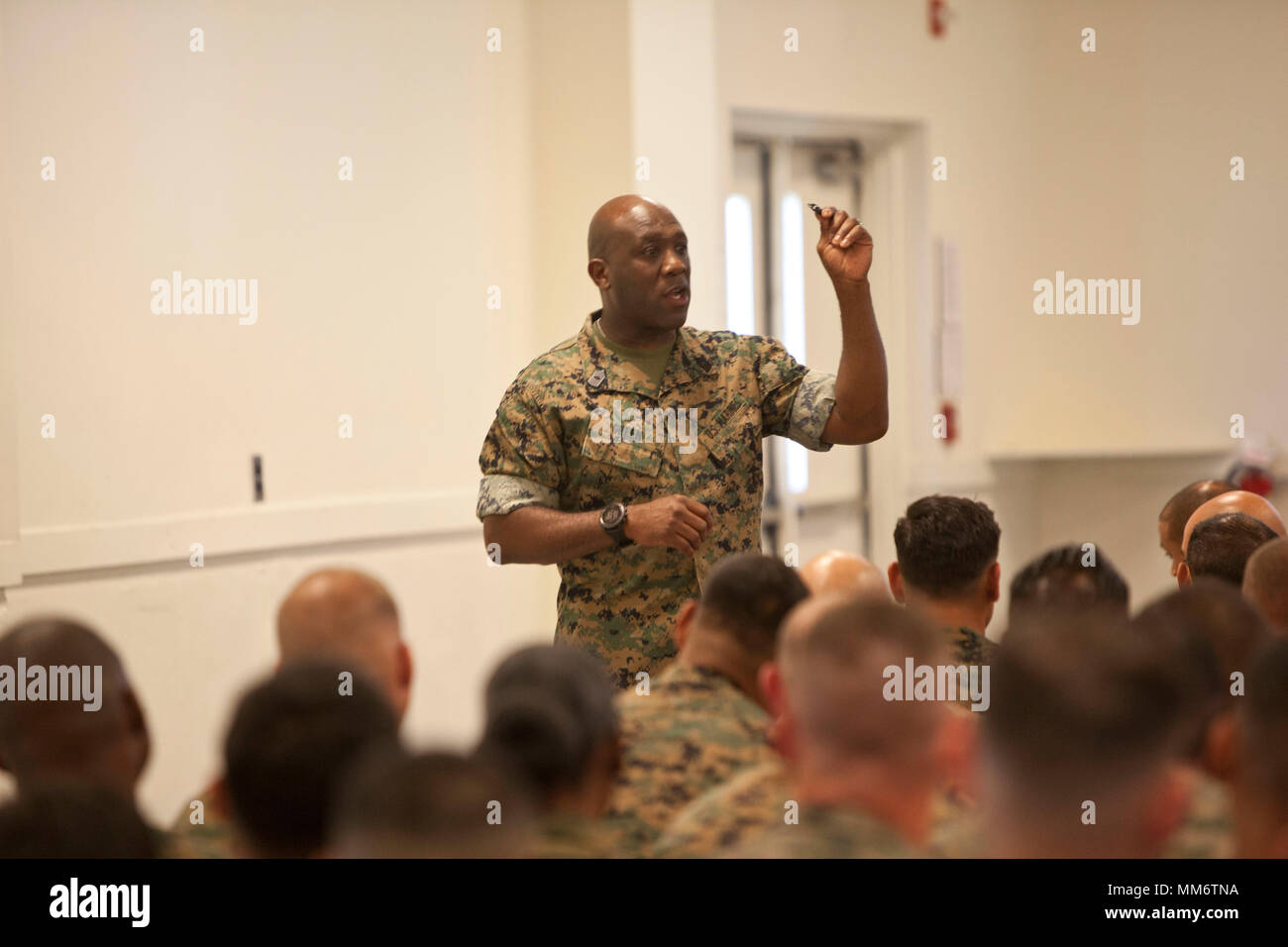 Sergeant Major of the Marine Corps Sgt. Maj. Ronald L. Green, holds up an eagle, globe and anchor while he speaks of never losing motivation to the Marines of  Staff Non-Commissioned Officers Academy at Camp Johnson N.C. Sept. 7, 2017. Sgt. Maj. Green visited Camp Johnson to speak to Marines on various subjects pertaining to the Marine Corps and answered questions from the audience. (U.S. Marine Corps photo by Lance Cpl Tyler Pender) Stock Photo