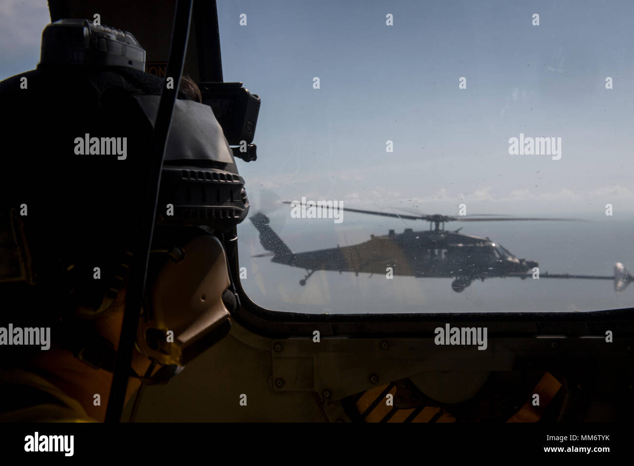 A pararescueman assigned to the 48th Rescue Squadron, watches as an HC ...