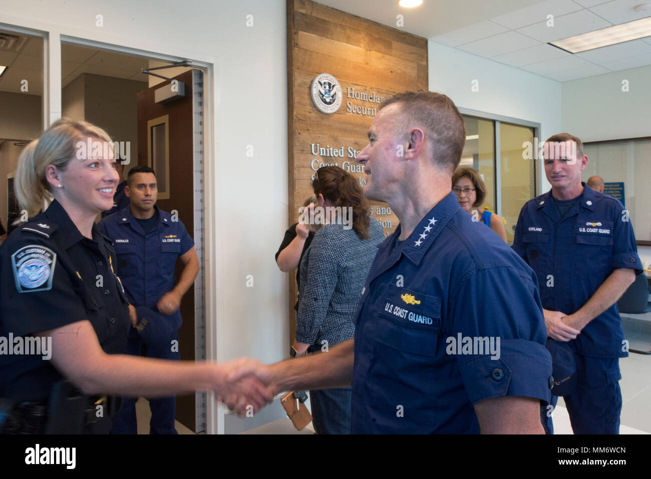 Adm. Paul Zukunft, right, Commandant of the U.S. Coast Guard, greets a ...