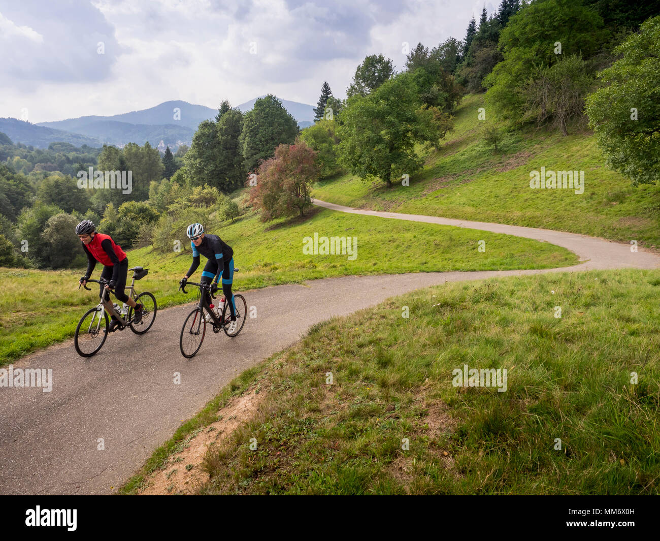 Two men riding racing bicycle on cycling tour in the Black Forest, Germany Stock Photo