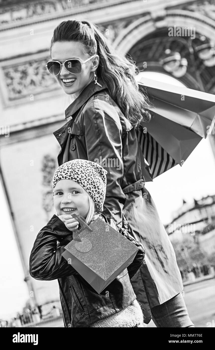 Stylish autumn in Paris. happy modern mother and child with shopping