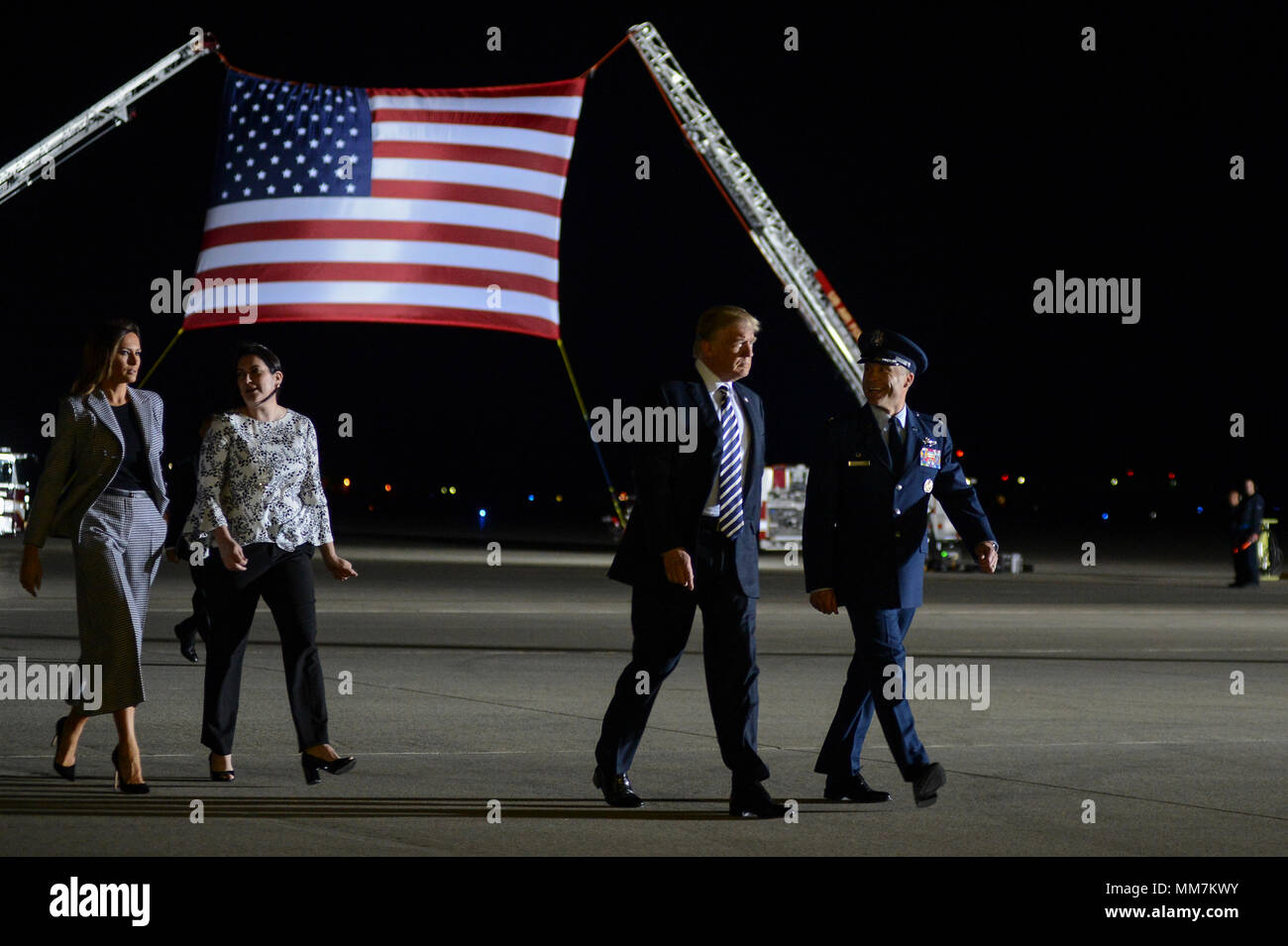 U.S. President Donald Trump and First Lady Melania Trump walk with Col. Casey D. Eaton, 89th Airlift Wing commander and his wife Lisa Eaton as they arrive to welcome home three American detainees freed by North Korea at Joint Base Andrews May 10, 2018 in Clinton, Maryland. The three include Kim Dong-chul, Tony Kim and Kim Hak-song released as a gesture of goodwill ahead of the planned meeting between Trump and North Korean leader Kim Jong-un. Stock Photo